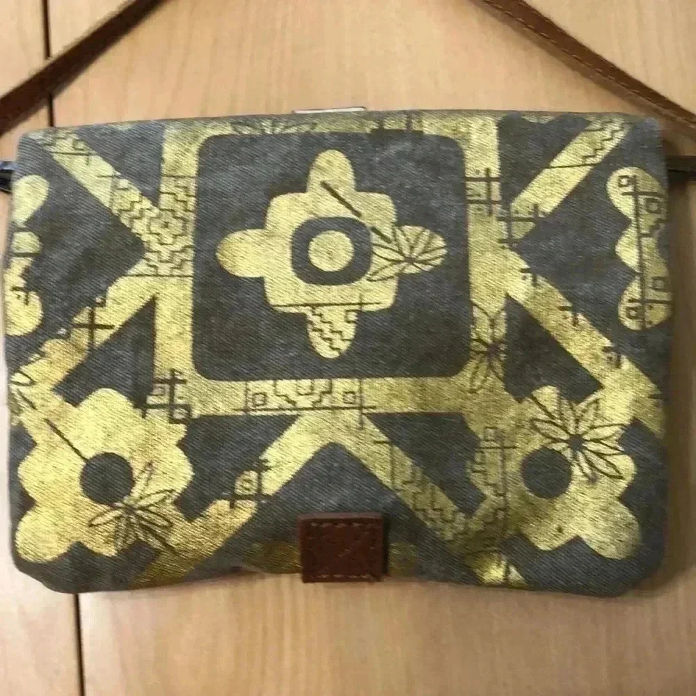 Mona B. Fold over crossbody bag. Tan/gold design.